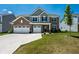 Charming two-story home featuring a brick facade, gray siding, and a well-maintained front yard at 9407 Casey Rd, Pendleton, IN 46064