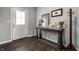 Bright foyer with wood floors, a decorative table, mirror, and a coat rack near the front door at 9407 Casey Rd, Pendleton, IN 46064