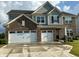 Charming two-story brick home featuring a three-car garage, manicured lawn and neutral colored siding at 9407 Casey Rd, Pendleton, IN 46064