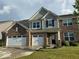 Charming two-story brick home featuring a three-car garage, manicured lawn and neutral colored siding at 9407 Casey Rd, Pendleton, IN 46064