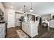 Well-lit kitchen with an island, stainless steel appliances, and hardwood floors, open to living space at 9407 Casey Rd, Pendleton, IN 46064
