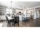 Modern kitchen featuring an island with seating, stainless steel appliances, and a dining area at 9407 Casey Rd, Pendleton, IN 46064