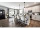 Bright kitchen featuring an island with pendant lighting, stainless steel appliances, and hardwood floors at 9407 Casey Rd, Pendleton, IN 46064
