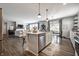 Open-concept kitchen with island seating flows seamlessly into the living area, with hardwood floors at 9407 Casey Rd, Pendleton, IN 46064