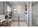Walk-in shower with gray tile, glass door, built-in bench, and shower caddy at 9407 Casey Rd, Pendleton, IN 46064