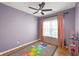 Bright bedroom with a hopscotch rug, ceiling fan, and closet at 9858 Bryce Blvd, Pendleton, IN 46064