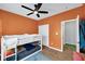 Charming bedroom featuring a bunk bed, a fun rug, and bright orange walls, ideal for  at 9858 Bryce Blvd, Pendleton, IN 46064