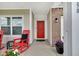 Inviting front porch with red rocking chairs and a bright red front door, offering a warm welcome at 9858 Bryce Blvd, Pendleton, IN 46064