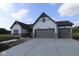 Charming home featuring a gray roof, three-car garage and light siding at 10424 Oak Bend Blvd, Indianapolis, IN 46239