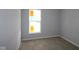 Simple bedroom with fresh paint, carpet, and a bright window for natural light at 10602 Maidenhair Dr, Indianapolis, IN 46239