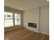 Bright living room featuring large windows and a modern electric fireplace at 10602 Maidenhair Dr, Indianapolis, IN 46239