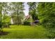 Spacious backyard with lush green grass, mature trees, architectural house, and plenty of room for recreation at 11544 Crestwood Ct, Indianapolis, IN 46239