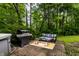 Backyard patio featuring a grill, outdoor furniture, and a hot tub, perfect for outdoor relaxation and entertainment at 11544 Crestwood Ct, Indianapolis, IN 46239