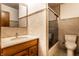 Updated bathroom with a tiled shower, a mirrored wall, and a vanity with a light countertop at 11544 Crestwood Ct, Indianapolis, IN 46239