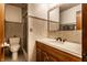 Well-lit bathroom with a wooden vanity and tiled shower at 11544 Crestwood Ct, Indianapolis, IN 46239