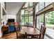 Cozy dining room boasts wood table, chairs, and natural light with hot tub view at 11544 Crestwood Ct, Indianapolis, IN 46239