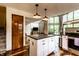 Modern kitchen featuring an island, hardwood floors, and stainless steel appliances at 11544 Crestwood Ct, Indianapolis, IN 46239