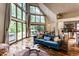 Bright living room features large windows, hardwood floors, and a comfortable blue sofa with decorative pillows at 11544 Crestwood Ct, Indianapolis, IN 46239