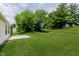 Large backyard with green grass and mature trees providing ample shade at 12121 Driftstone Dr, Fishers, IN 46037