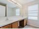 Bathroom with a large mirror, double sinks, and natural light from the window at 12121 Driftstone Dr, Fishers, IN 46037
