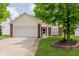 Charming single-story home with brick accents, a two-car garage, and a well-maintained lawn and landscape at 12121 Driftstone Dr, Fishers, IN 46037