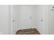 Hallway with wood-look floors and white doors at 12121 Driftstone Dr, Fishers, IN 46037