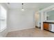 Bright kitchen area with stainless steel dishwasher, leading to dining and living area with tile flooring at 12121 Driftstone Dr, Fishers, IN 46037