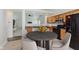 Cozy kitchen featuring wood cabinets, dark countertops, and breakfast nook with a dining table set at 12121 Driftstone Dr, Fishers, IN 46037
