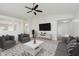Bright living room featuring a ceiling fan, neutral color palette, and comfortable seating arrangement at 12121 Driftstone Dr, Fishers, IN 46037