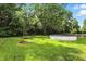 Lush backyard with a fire pit, above-ground pool, and mature trees for privacy and outdoor enjoyment at 1224 S Hunter Rd, Indianapolis, IN 46239