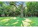 Large backyard with lush greenery and mature trees at 1224 S Hunter Rd, Indianapolis, IN 46239