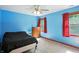 Cozy bedroom with bright blue walls, natural light, and wood trim at 1224 S Hunter Rd, Indianapolis, IN 46239
