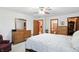 View of the bedroom with wooden floors and featuring a mirrored dresser and closet access at 1224 S Hunter Rd, Indianapolis, IN 46239