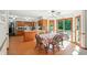 Open concept eat-in dining area with wood table and flooring next to bright kitchen at 1224 S Hunter Rd, Indianapolis, IN 46239