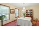 Cozy dining room featuring a chandelier, a classic china cabinet, and a formal dining table at 1224 S Hunter Rd, Indianapolis, IN 46239