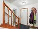 Bright entryway featuring a staircase with wooden banister, a white door, and a convenient coat rack at 1224 S Hunter Rd, Indianapolis, IN 46239