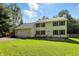 Traditional two-story home with an attached garage, black shutters, and a neatly landscaped front yard under a sunny sky at 1224 S Hunter Rd, Indianapolis, IN 46239