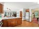 Traditional kitchen with stainless steel appliances, wood cabinets, and an attached breakfast bar with view to backyard at 1224 S Hunter Rd, Indianapolis, IN 46239