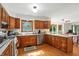 Traditional kitchen with stainless steel appliances, wood cabinets, and an eat-in breakfast bar overlooking backyard at 1224 S Hunter Rd, Indianapolis, IN 46239