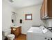 Functional laundry room featuring a sink, ample counter space, and upper cabinets for convenient storage at 1224 S Hunter Rd, Indianapolis, IN 46239