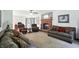 Large living room with a brick fireplace and plenty of comfortable seating for entertaining at 1224 S Hunter Rd, Indianapolis, IN 46239