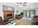 Cozy living room with a brick fireplace and plenty of natural light from windows at 1224 S Hunter Rd, Indianapolis, IN 46239
