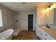 Modern bathroom showcasing a soaking tub, walk-in shower, and stylish vanity for a spa-like experience at 12400 French Cattle Way, Noblesville, IN 46060