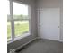 Cozy bedroom showcasing a sliding door closet, natural light from a window, and neutral carpet at 12400 French Cattle Way, Noblesville, IN 46060