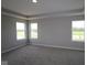 Spacious bedroom with three large windows and neutral carpeting for a comfortable living space at 12400 French Cattle Way, Noblesville, IN 46060