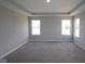 Large bedroom featuring tray ceiling, neutral carpet, and two large windows offering natural light at 12400 French Cattle Way, Noblesville, IN 46060