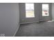 Well-lit bedroom with plush carpeting and two windows, offering a comfortable and inviting space at 12400 French Cattle Way, Noblesville, IN 46060