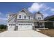 Charming two-story home with a three-car garage and modern farmhouse accents under a blue sky at 12400 French Cattle Way, Noblesville, IN 46060