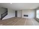 Bright living room featuring a modern fireplace, recessed lighting, and stairs with a black iron railing at 12400 French Cattle Way, Noblesville, IN 46060