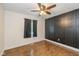 Spacious bedroom featuring hardwood floors, ceiling fan, and a large window at 12661 Doe Ln, Indianapolis, IN 46236
